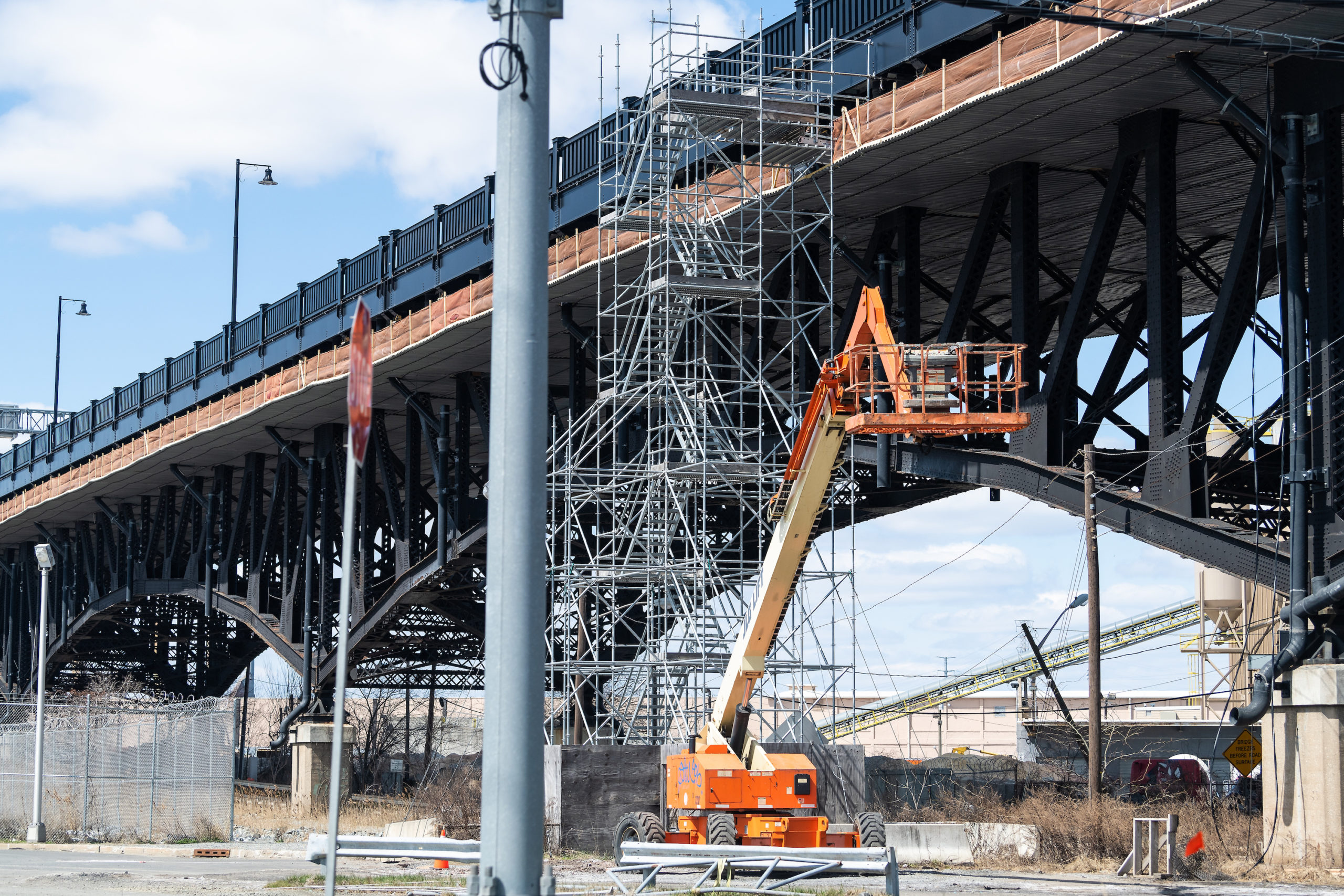 construction lien concept Jersey City, USA - April 6, 2018: Industrial view in downtown city area in New Jersey with construction on bridge