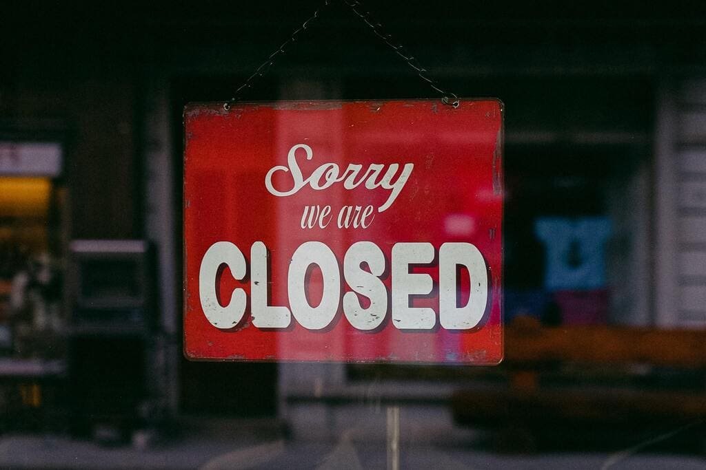 A closed sign on a business entrance